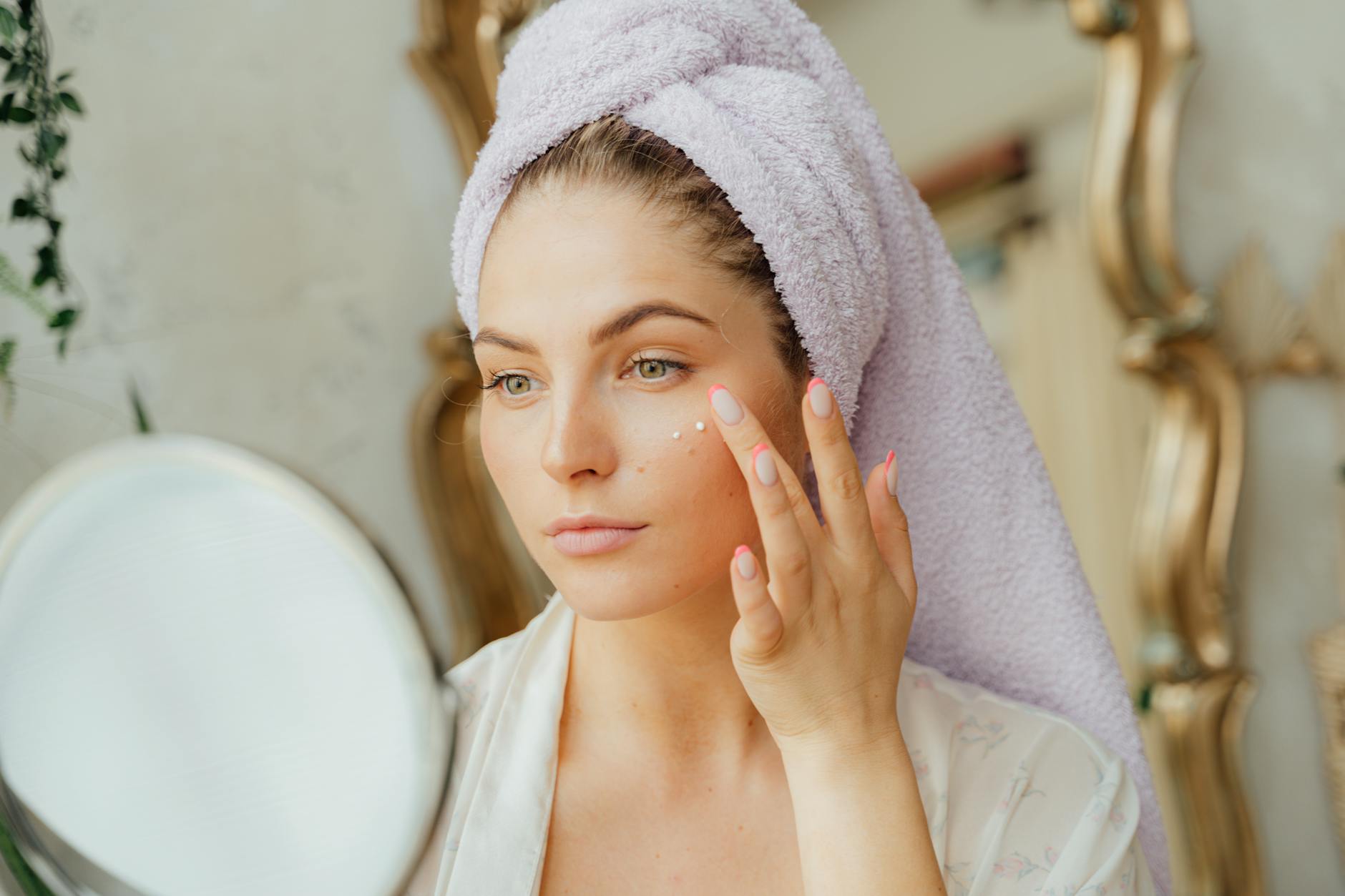 Woman applying moisturiser as part of a skincare routine