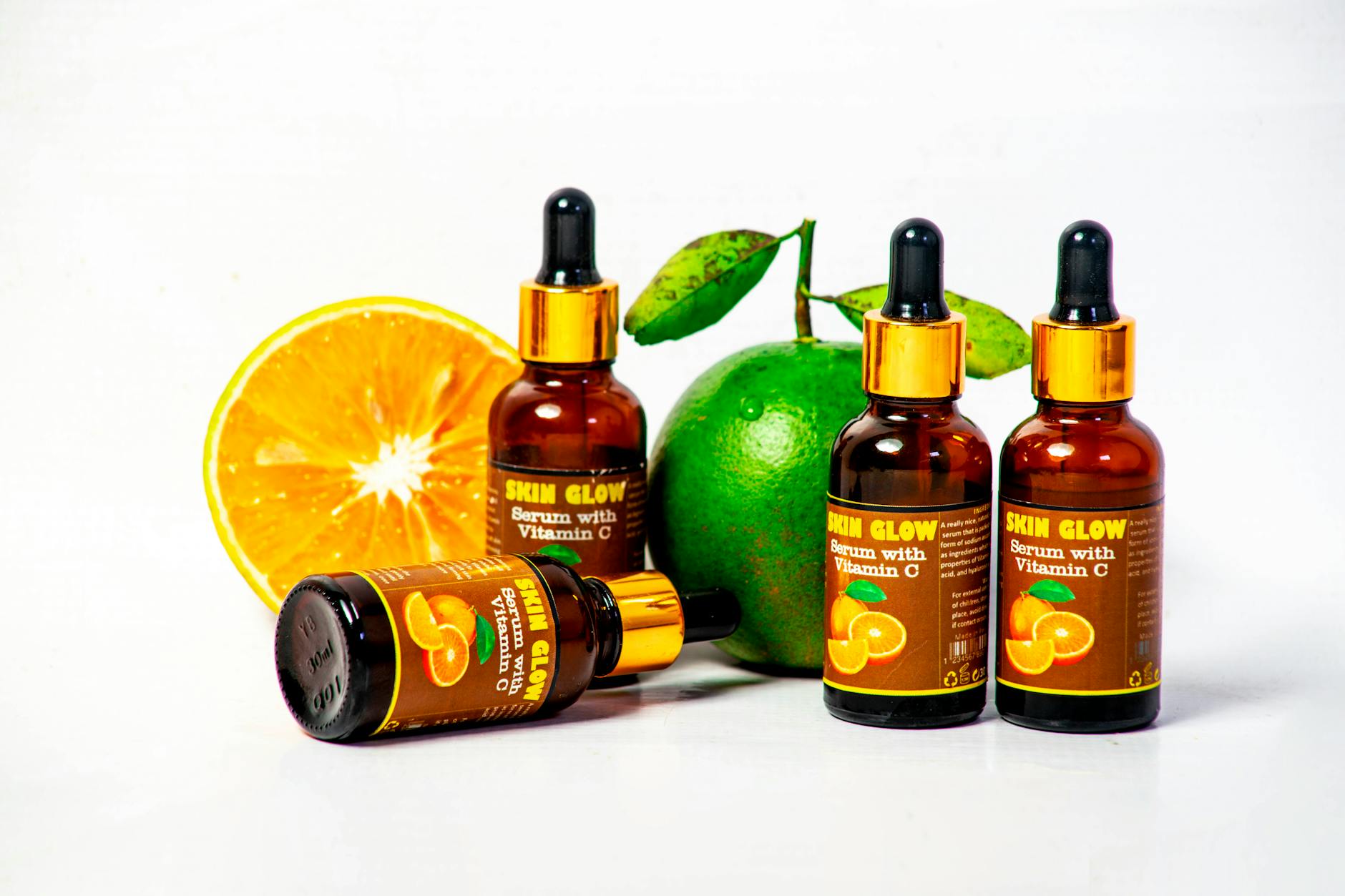 Vitamin C serum bottles with fresh citrus fruits for skincare and health promotion
