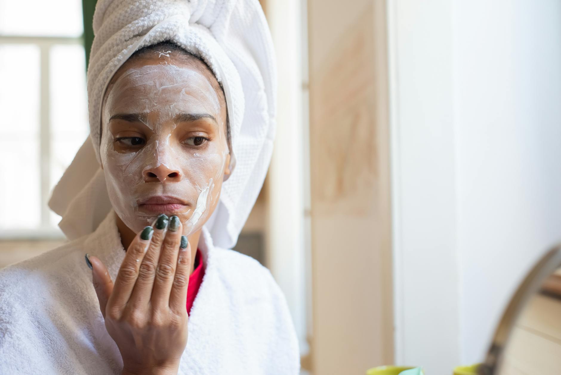 Woman applying skincare product as part of her daily routine