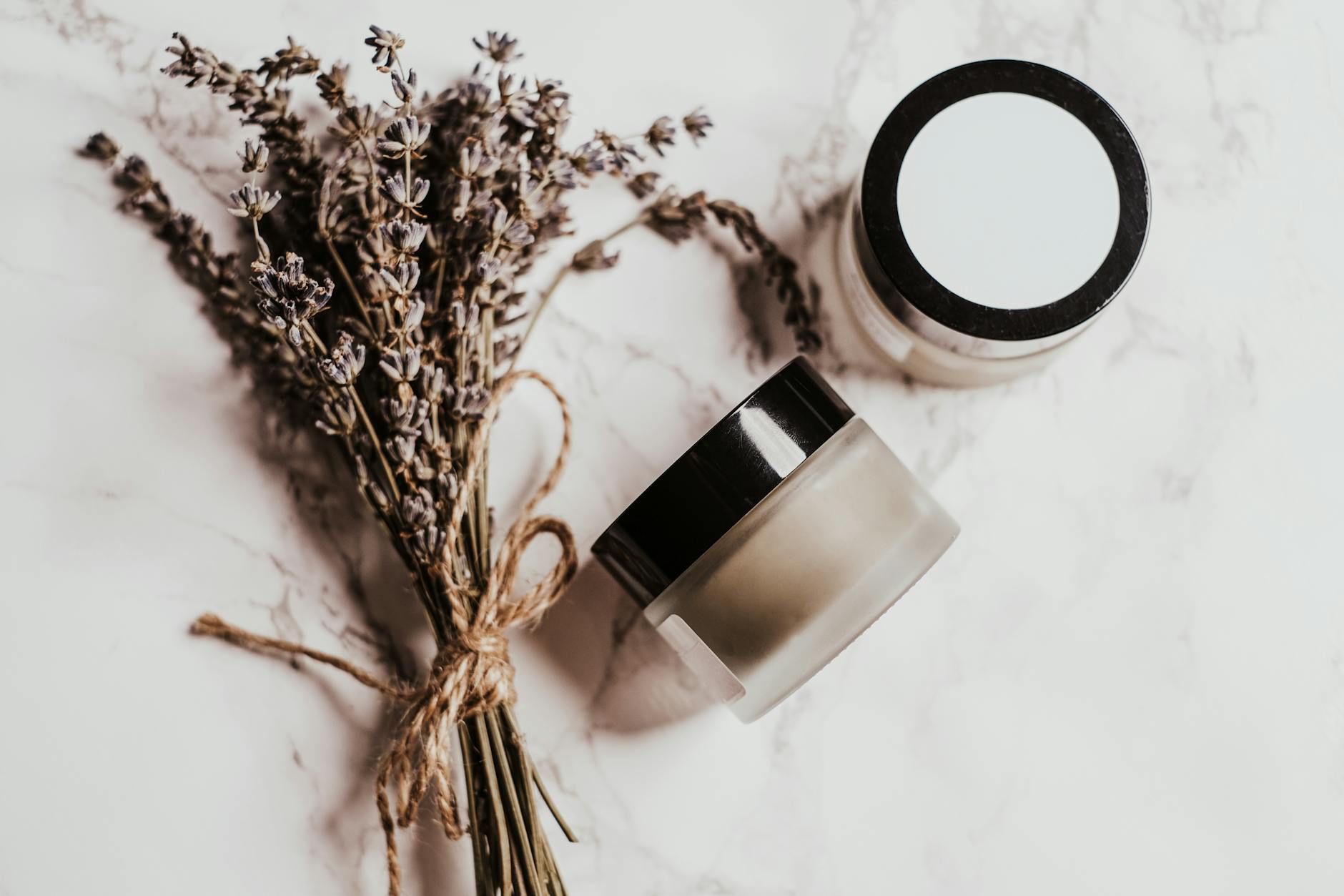 Elegant display of skincare products and lavender on a marble surface