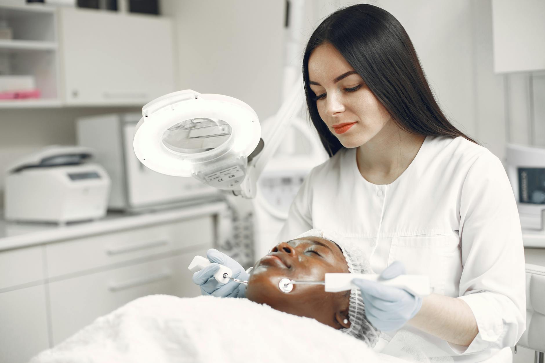 Professional practitioner applying a facial skincare treatment in a clinical setting