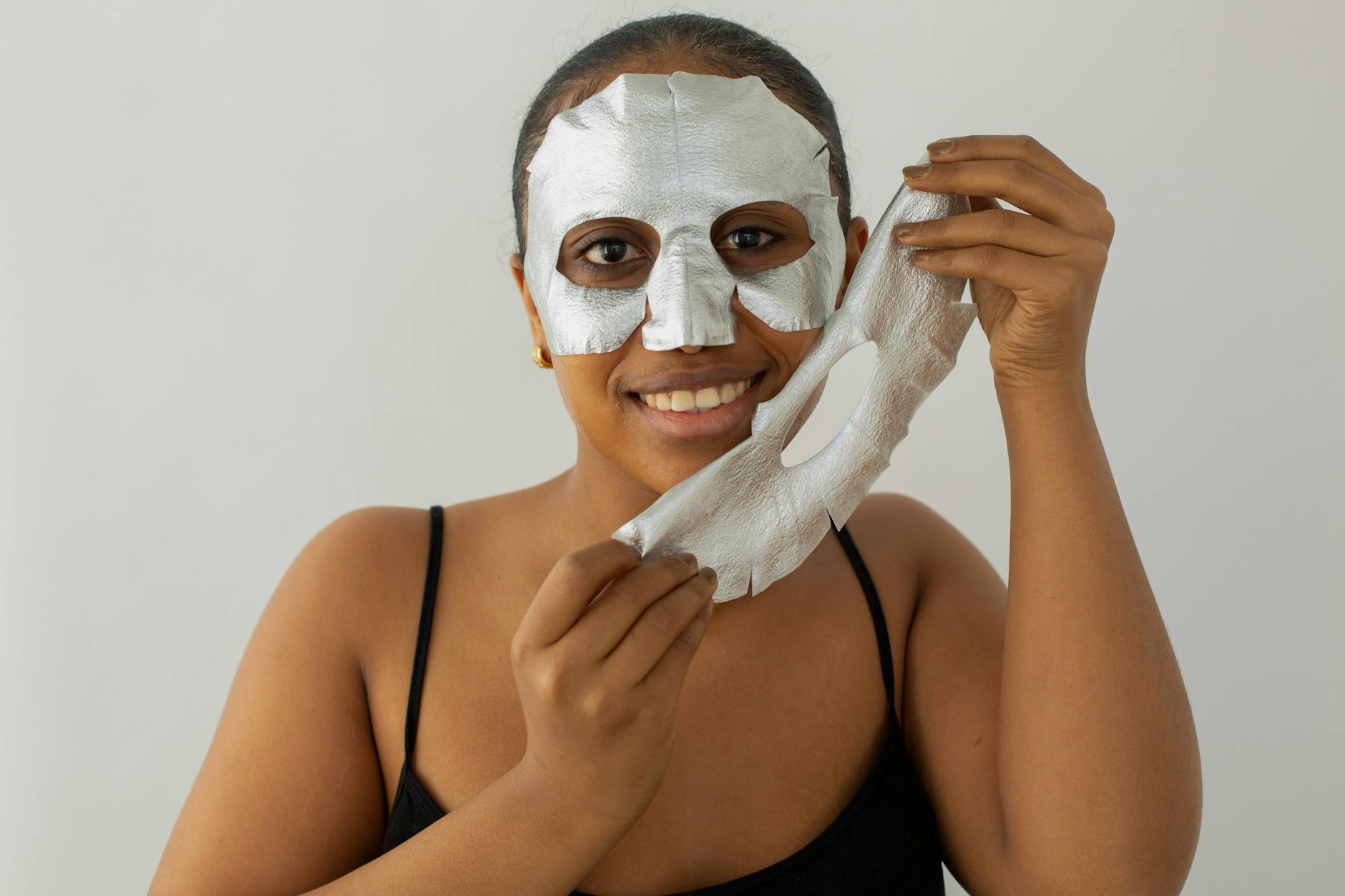 Woman applying a facial skincare treatment, representing post-peel recovery care