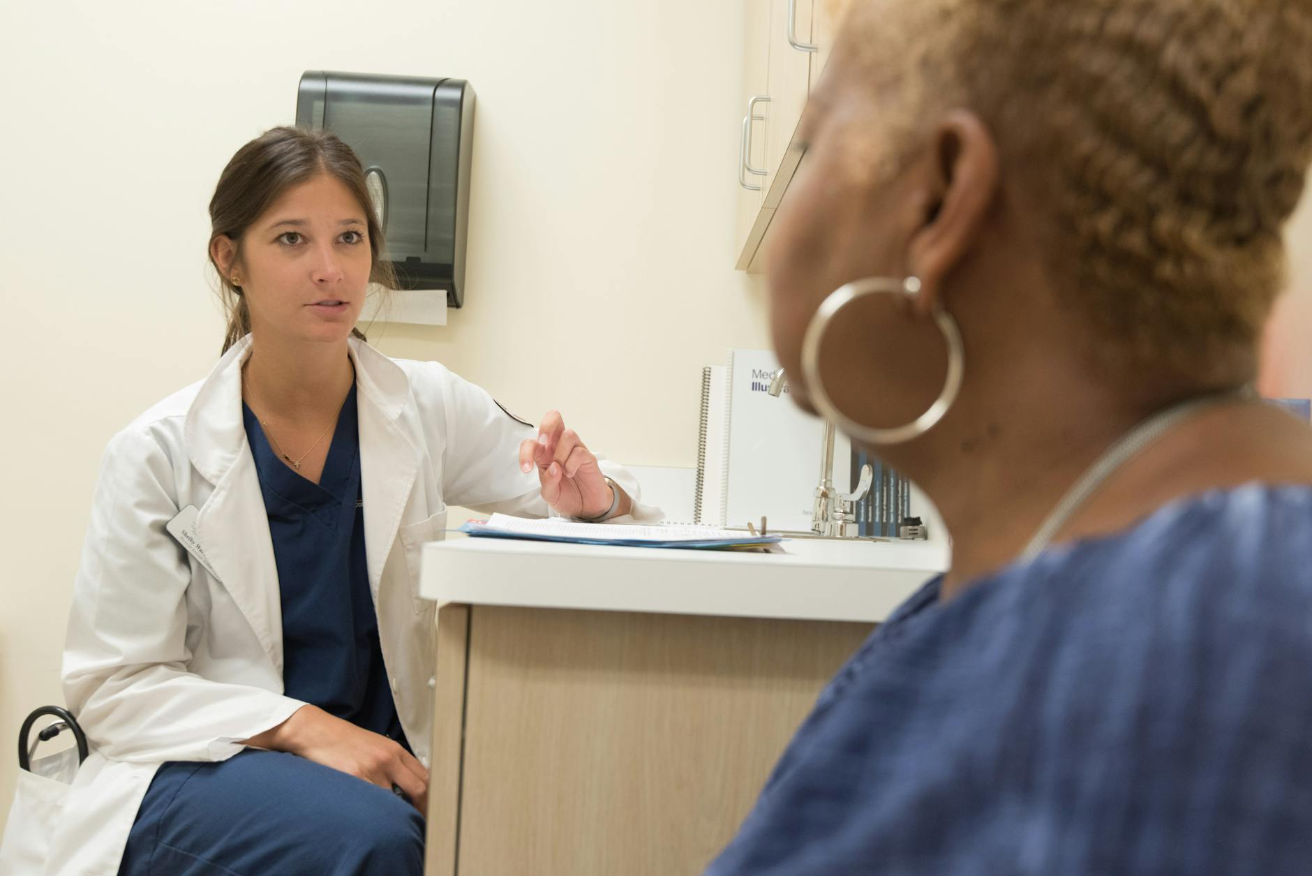 Doctor in consultation with a patient at a medical clinic discussing treatment options