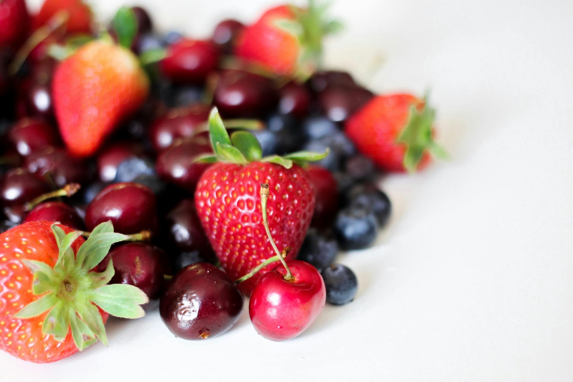 Fresh strawberries, cherries, and blueberries rich in polyphenols and antioxidants that support skin health