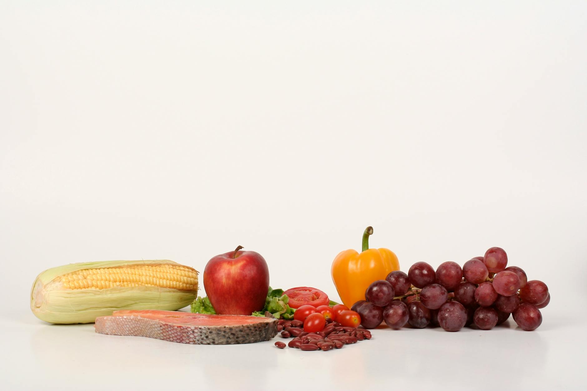 Vibrant display of fruits, vegetables, and salmon representing the nutrients linked to skin health