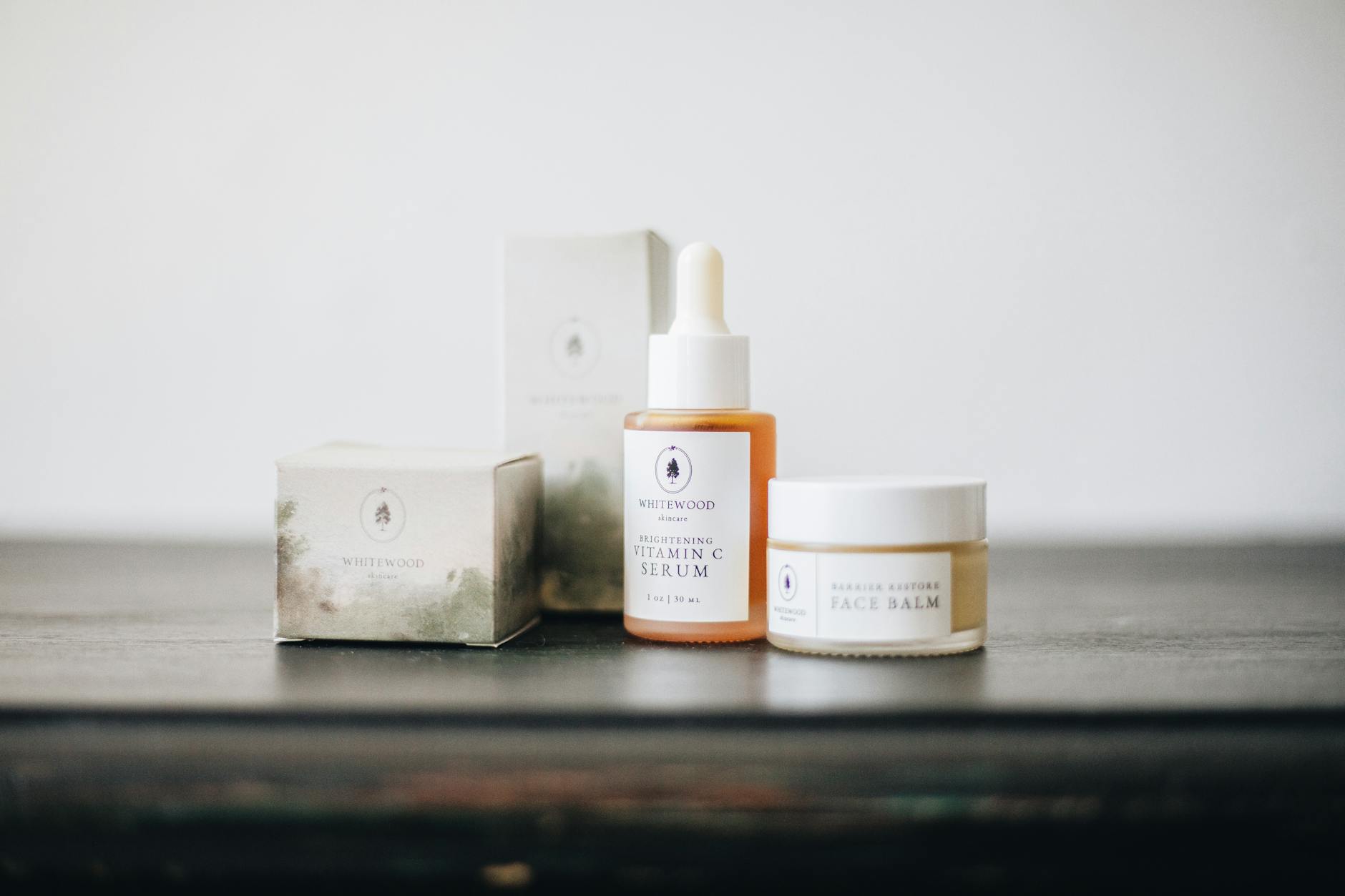 Flat lay of natural skincare products including vitamin C serum and face balm on a clean surface